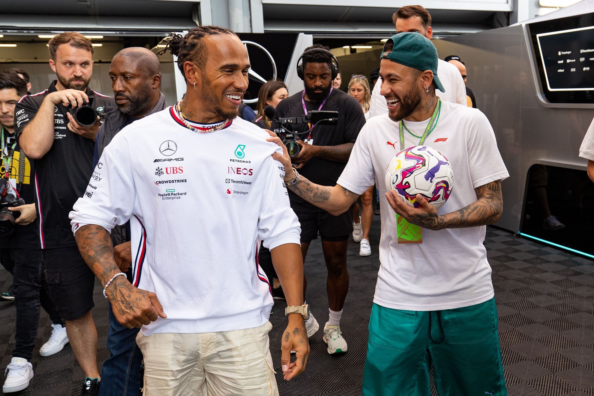 Lewis Hamilton shares a joke with Brazilian footballer Neymar during the 2023 F1 Grand Prix of Spain - Source: Getty